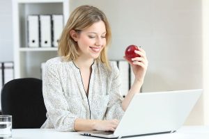 Business professional reading the latest from Unitek News on their laptop